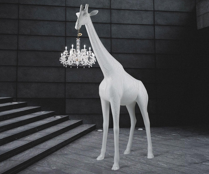 Life-Size Giraffe Statue Holding a Chandelier In Its Mouth