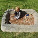 Discreet Landscaping Boulder Sandbox