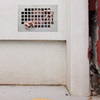 Man Trapped Behind a Wall Grate Graphic