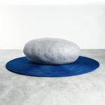 Zen Kusshion - Giant Stone Pillow on a Rippling Blue Rug